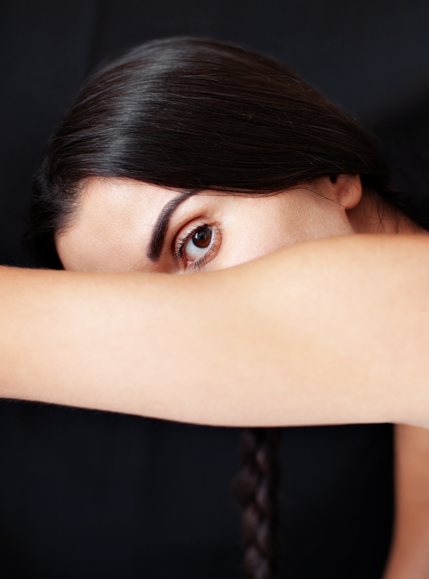Surreal woman portrait. Abstract fashion surrealistic face, close up eye on black background