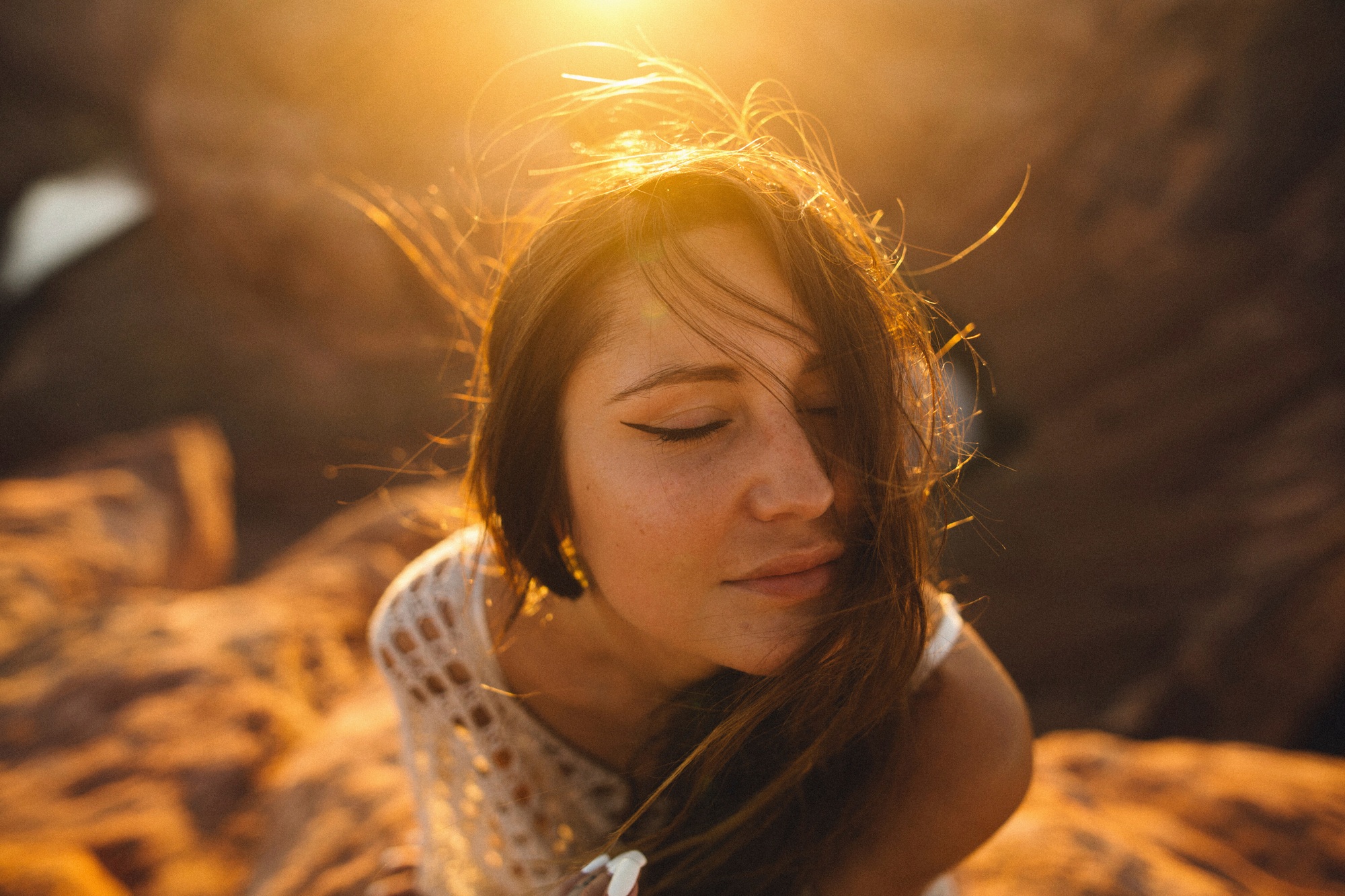 Woman enjoying sunlight with a serene expression.